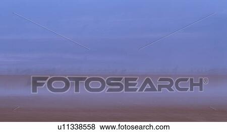 Abstract panorama view of wildebeest running in dust of Amboseli lake bed with motion blur, Amboseli, Kenya, East Africa View Large Photo Image Stock Photo - Abstract panorama view of wildebeest running in dust of Amboseli lake bed with motion blur, Amboseli, Kenya, East Africa. Fotosearch