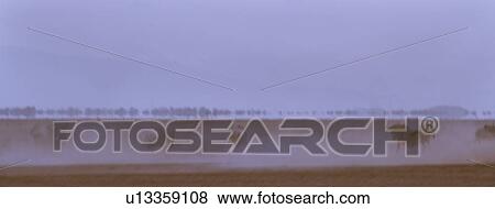 Abstract panorama view of wildebeest running in dust of Amboseli lake bed with motion blur, Amboseli, Kenya, East Africa View Large Photo Image Stock Photo - Abstract panorama view of wildebeest running in dust of Amboseli lake bed with motion blur, Amboseli, Kenya, East Africa. Fotosearch