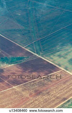 Aerial view of cultivated and ploughed fields creating graphic diagonal lines, brown and green, Kenya, East Africa View Large Photo Image Stock Image - Aerial view of cultivated and ploughed fields creating graphic diagonal lines, brown and green, Kenya, East Africa. Fotosearch