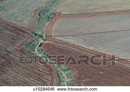 Stock Photograph - Aerial view of cultivated and ploughed fields creating graphic diagonal lines, brown and green, Kenya, East Africa. Fotosearch