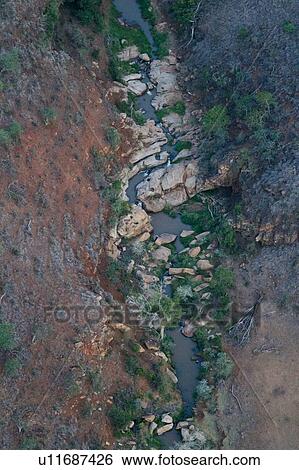 Aerial view of dry rocky river bed and surrounding slopes in Lewa Downs plain, Kenya, East Africa View Large Photo Image Stock Photograph - Aerial view of dry rocky river bed and surrounding slopes in Lewa Downs plain, Kenya, East Africa. Fotosearch