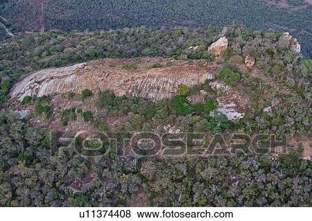 Stock Photo - Aerial view of rocky outcrop, and trees, Lewa Downs, Kenya, East Africa. Fotosearch