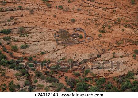 Aerial view of sandy Lewa Downs plain with circular outline of Masai village, scattered acacia trees, Lewa Downs, Kenya, East Africa View Large Photo Image Stock Image - Aerial view of sandy Lewa Downs plain with circular outline of Masai village, scattered acacia trees, Lewa Downs, Kenya, East Africa. Fotosearch