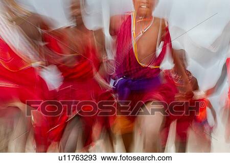 Masai Olympics: group of Masai warriors, all dressed in traditional red and blue shukas, running race very close towards viewer, motion blur effect, Amboseli, Kenya, East Africa View Large Photo Image Stock Image - Masai Olympics: group of Masai warriors, all dressed in traditional red and blue shukas, running race very close towards viewer, motion blur effect, Amboseli, Kenya, East Africa. Fotosearch