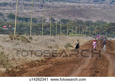 Women dressed in brightly coloured dresses walking along road, Lewa Downs, Kenya, East Africa View Large Photo Image Stock Image - Women dressed in brightly coloured dresses walking along road, Lewa Downs, Kenya, East Africa. Fotosearch
