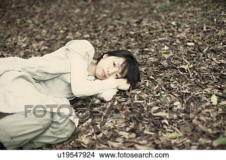 Picture - A young woman in the forest. Fotosearch
