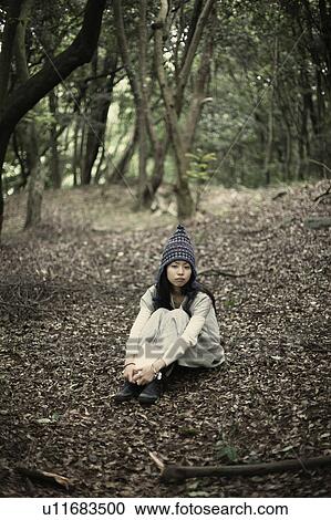 Stock Image - A young woman in the forest. Fotosearch