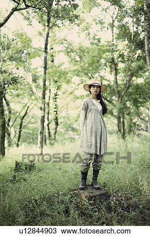 Stock Image - A young woman in the forest. Fotosearch
