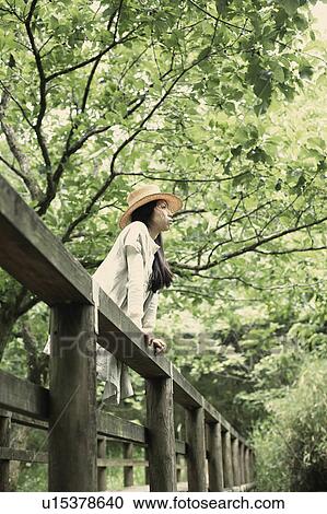 Stock Image - A young woman in the forest. Fotosearch