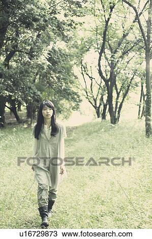 A young woman in the forest View Large Photo Image Stock Image - A young woman in the forest. Fotosearch