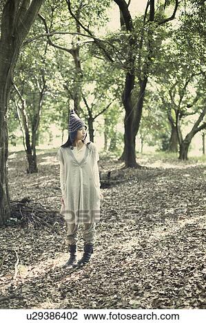 Stock Image - A young woman in the forest. Fotosearch