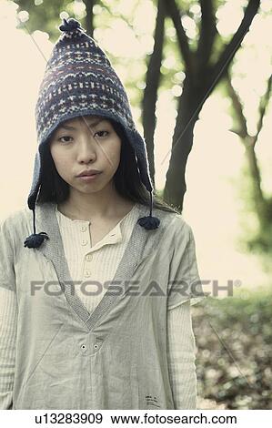 Stock Photo - A young woman in the forest. Fotosearch