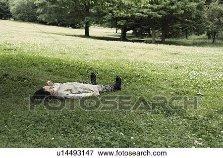 Stock Photo - A young woman in the forest. Fotosearch