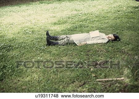 Stock Photo - A young woman in the forest. Fotosearch