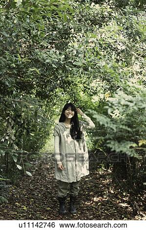 A young woman in the forest View Large Photo Image Stock Photograph - A young woman in the forest. Fotosearch