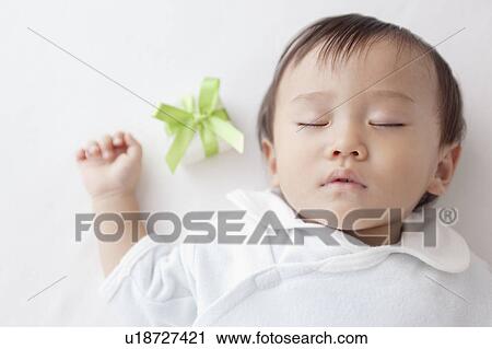 Baby Boy Sleeping Next to Gift Box View Large Photo Image Stock Image - Baby Boy Sleeping Next to Gift Box. Fotosearch