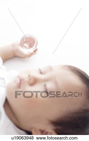 Stock Photo - Baby Boy Sleeping with Globe in Hand. Fotosearch