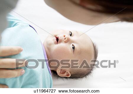 Stock Photo - Baby Girl Looking at Mother. Fotosearch