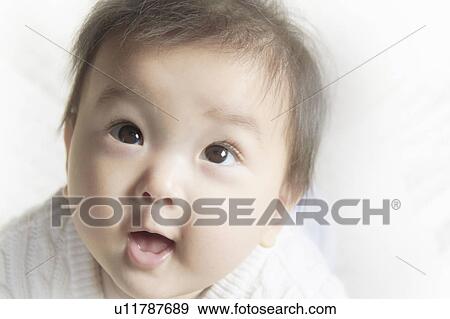 Stock Photo - Baby Looking Up in Awe. Fotosearch