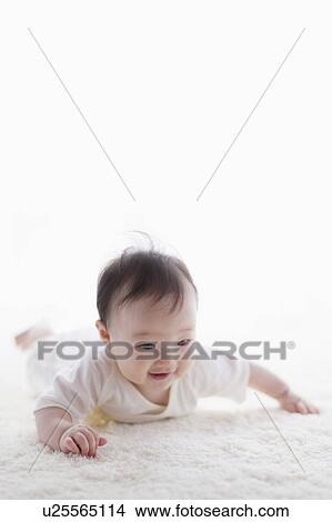 Baby lying on front View Large Photo Image Picture - Baby lying on front. Fotosearch