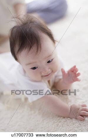 Stock Image - Baby lying on front. Fotosearch