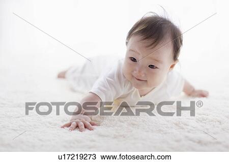 Stock Image - Baby lying on front. Fotosearch
