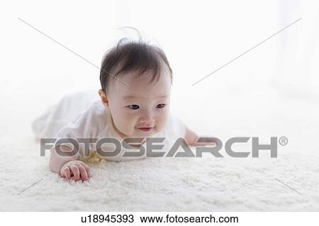 Baby lying on front View Large Photo Image Stock Image - Baby lying on front. Fotosearch