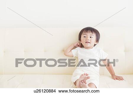 Boy Sitting on Sofa View Large Photo Image Picture - Boy Sitting on Sofa. Fotosearch