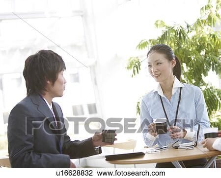 Stock Image - Businessman and Businesswoman Having Coffee Break. Fotosearch