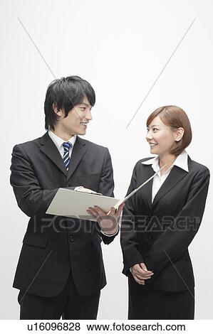 Businessman and Businesswoman Looking At File View Large Photo Image Stock Photo - Businessman and Businesswoman Looking At File. Fotosearch