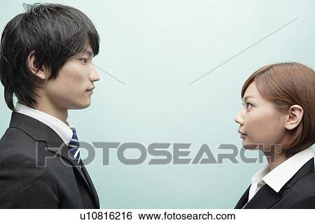 Stock Photograph - Businessman and Businesswoman Looking At Each Other. Fotosearch
