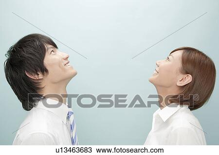 Stock Image - Businessman and Businesswoman Looking Up. Fotosearch
