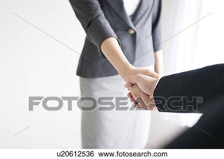 Businessman and Businesswoman Shaking Hands View Large Photo Image Stock Photograph - Businessman and Businesswoman Shaking Hands. Fotosearch