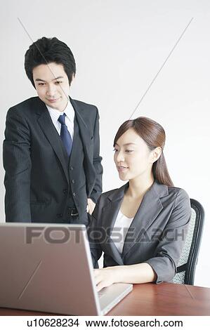 Businessman and Businesswoman Using Laptop View Large Photo Image Picture - Businessman and Businesswoman Using Laptop. Fotosearch