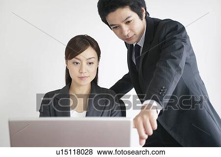Businessman and Businesswoman Using Laptop View Large Photo Image Stock Photo - Businessman and Businesswoman Using Laptop. Fotosearch