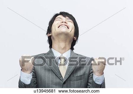 Stock Image - Businessman Celebrating with Clenched Fists. Fotosearch