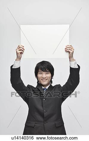 Stock Photograph - Businessman Holding Blank Message. Fotosearch