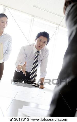 Stock Image - Businessman Talking in Meeting. Fotosearch