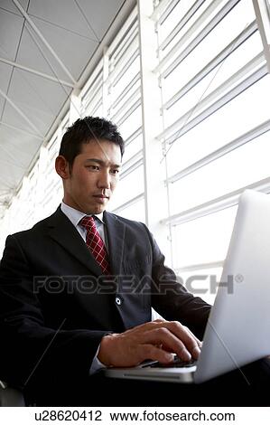Stock Image - Businessman Using Laptop. Fotosearch