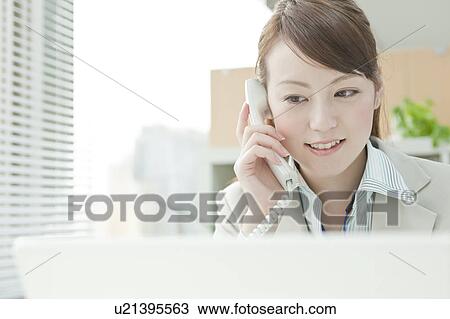 Businessman Woman Using Laptop and Talking on Phone View Large Photo Image Stock Image - Businessman Woman Using Laptop and Talking on Phone. Fotosearch
