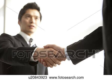 Stock Image - Businessmen Shaking Hands. Fotosearch