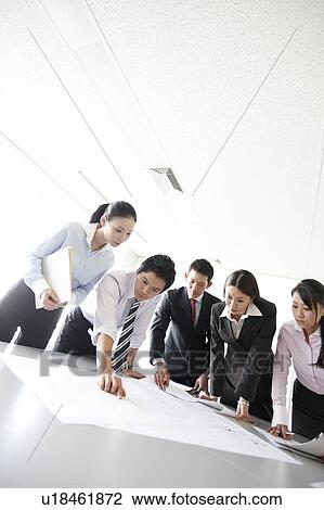 Businesspeople examining Blueprint in Meeting View Large Photo Image Stock Image - Businesspeople examining Blueprint in Meeting. Fotosearch