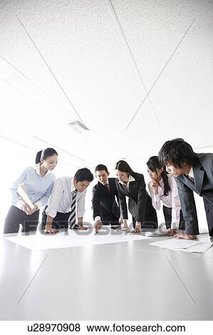 Businesspeople examining Blueprint in Meeting View Large Photo Image Stock Photo - Businesspeople examining Blueprint in Meeting. Fotosearch