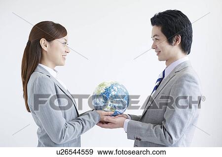 Businesspeople Holding Globe View Large Photo Image Stock Photo - Businesspeople Holding Globe. Fotosearch