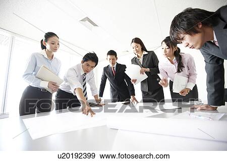 Businesspeople Looking at Documents in Meeting View Large Photo Image Stock Photo - Businesspeople Looking at Documents in Meeting. Fotosearch