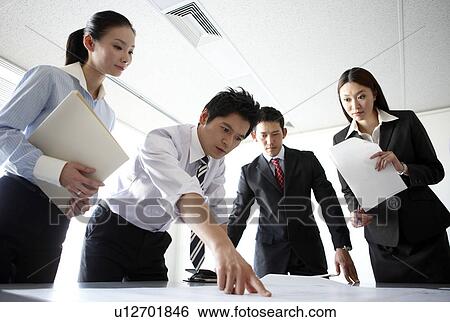 Businesspeople Looking at Documents in Meeting View Large Photo Image Stock Photograph - Businesspeople Looking at Documents in Meeting. Fotosearch