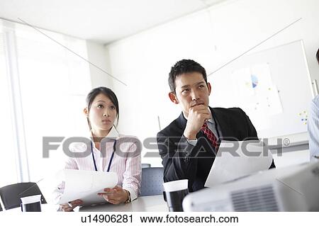Stock Image - Businesswoman and Businessman in Meeting. Fotosearch