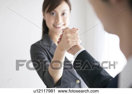Businesswoman and Businessman Shaking Hands View Large Photo Image Stock Image - Businesswoman and Businessman Shaking Hands. Fotosearch