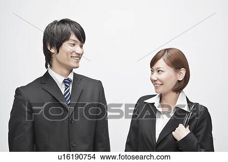 Businesswoman and Businessman Smiling at Each Other View Large Photo Image Picture - Businesswoman and Businessman Smiling at Each Other. Fotosearch