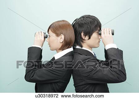 Businesswoman and Businessman Standing Back To Back and Looking Through Binoculars View Large Photo Image Stock Image - Businesswoman and Businessman Standing Back To Back and Looking Through Binoculars. Fotosearch